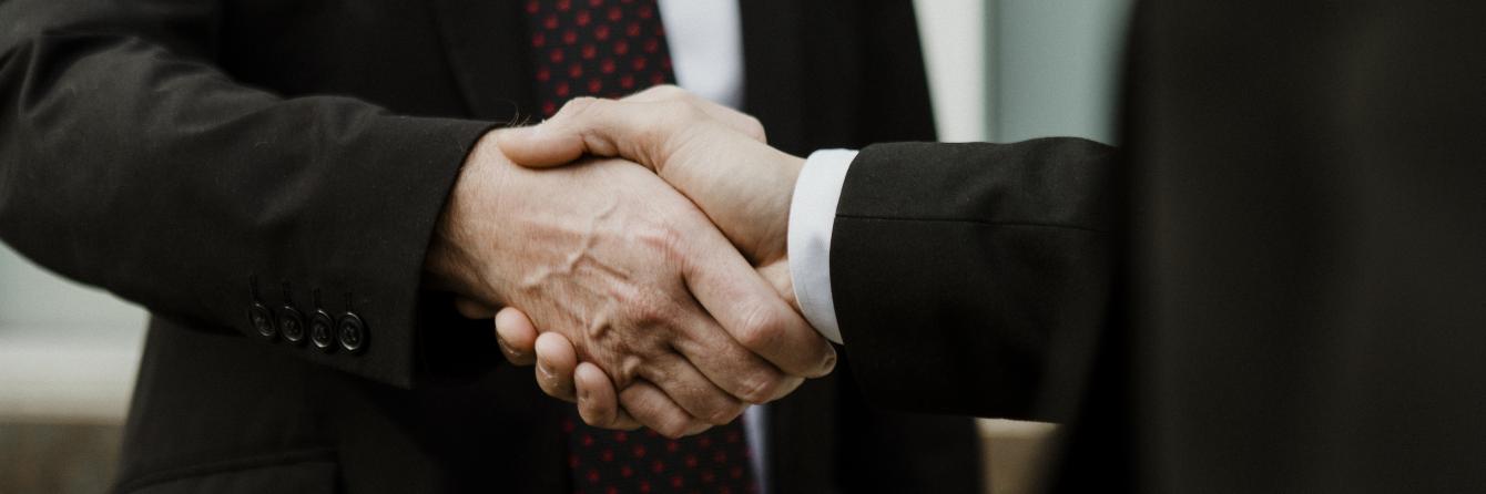 Corporate handshake - Extraco LINC